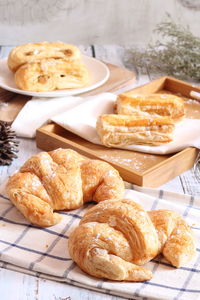 One delicious croissant is placed on a white plate.