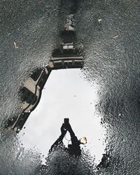 Reflection of building in puddle