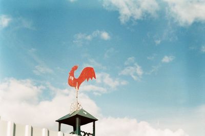 Low angle view of chicken bird sculpture against sky
