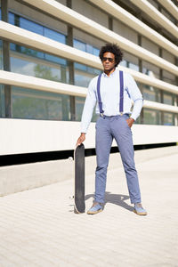 Portrait of young man standing against wall