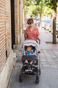 Young mother takes a walk with young baby