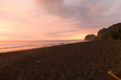 Scenic view of beach against sky during sunset