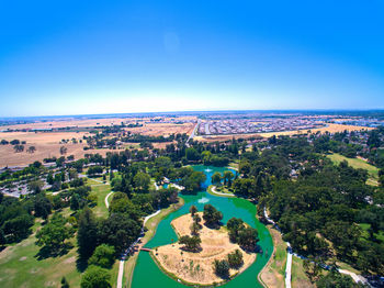High angle view of swimming pool against clear blue sky