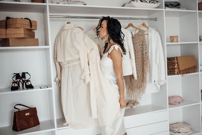 Side view of woman trying on clothes in store