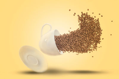 Close-up of drink on table against white background