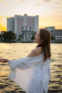 Portrait of young woman looking at sea