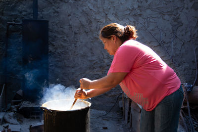 Woman preparing south american traditional food outdoors