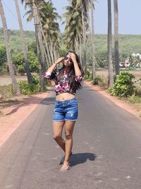 Full length portrait of woman on road