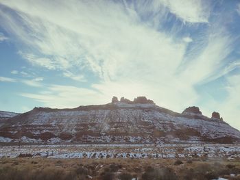 Low angle view of snowcapped mountain against sky