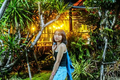 Portrait of girl standing by trees