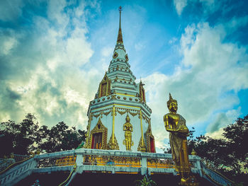 Low angle view of temple building against cloudy sky