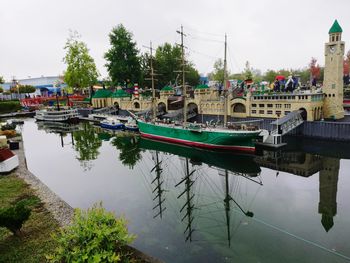 Boats moored in river against sky