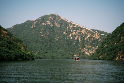 Scenic view of river amidst mountains against sky