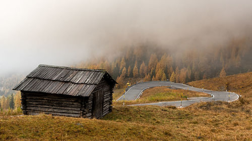 Built structure on field against sky in autumn