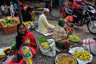 People sitting at market stall