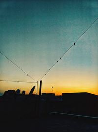 Silhouette street against sky at dusk