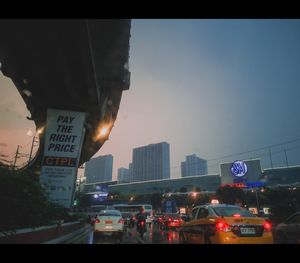 Cars on road in city at dusk