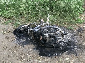 High angle view of abandoned motorcycle on field