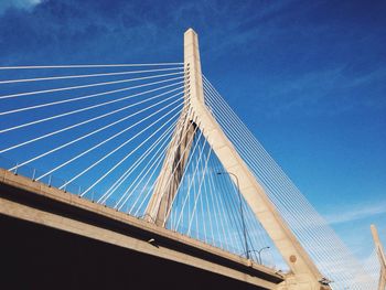 Low angle view cable-stayed bridge against blue sky