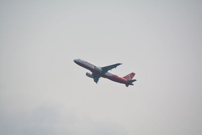 Low angle view of airplane flying in sky