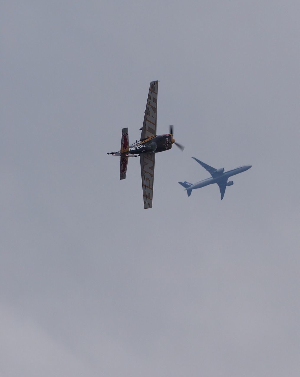 airplane, air vehicle, flying, low angle view, mode of transport, transportation, mid-air, wind power, travel, public transportation, sky, military airplane, clear sky, windmill, copy space, environmental conservation, renewable energy, on the move, wind turbine, alternative energy