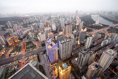 High angle view of illuminated cityscape against sky