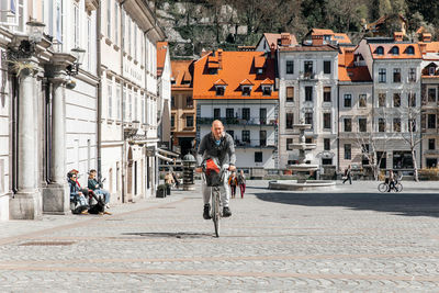 Portrait of a handsome hipster man. a man in a big city cycling down the street on a bicycle