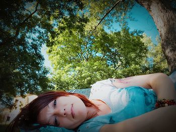 Portrait of young woman against blue sky