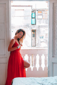 Woman standing by window