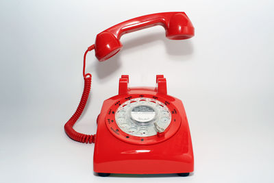 Close-up of telephone on red background