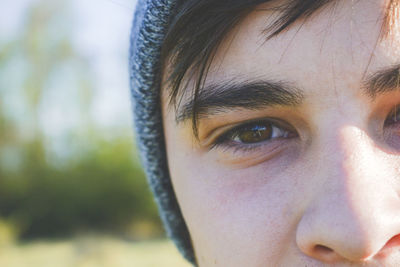 Cropped image of young man wearing knit hat