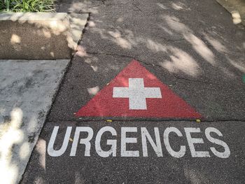 High angle view of arrow sign on road in city