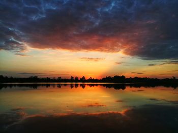 Scenic view of lake against romantic sky at sunset