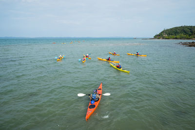 High angle view of people enjoying in sea