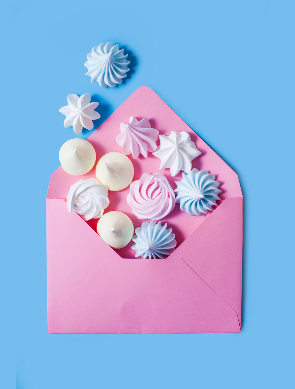 HIGH ANGLE VIEW OF PINK PAPER ON BLUE TABLE