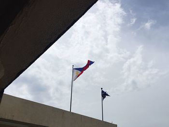 Low angle view of flags against sky