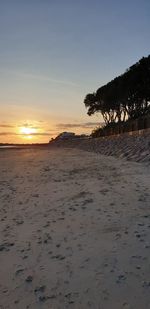 Scenic view of beach against sky during sunset