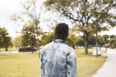 Rear view of woman standing in park