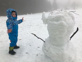 Full length of girl standing in snow