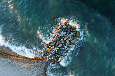 High angle view of rocks in sea