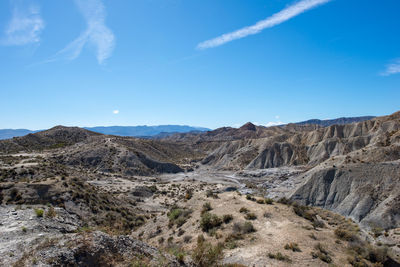 Scenic view of rocky mountains against blue sky