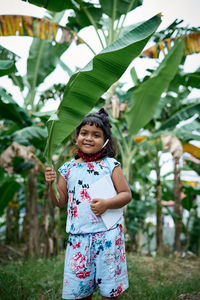 Portrait of smiling girl standing outdoors