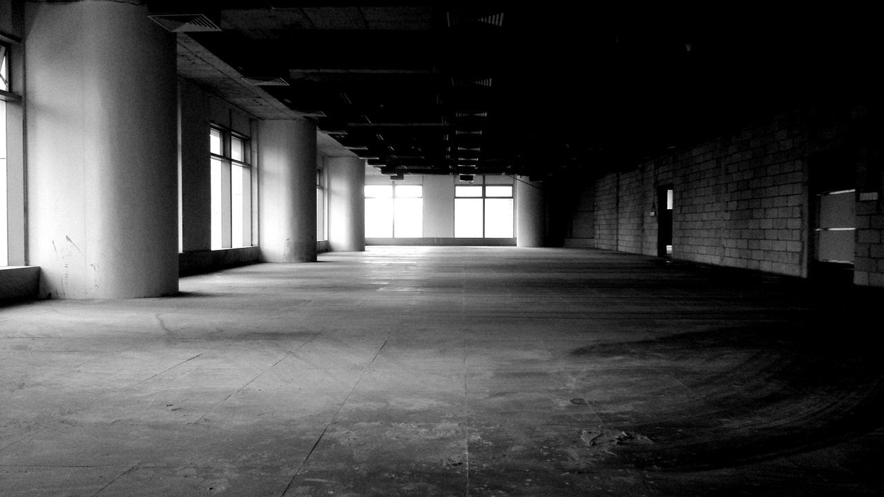 indoors, architecture, built structure, corridor, the way forward, empty, diminishing perspective, building, ceiling, flooring, absence, narrow, wall - building feature, in a row, architectural column, vanishing point, wall, door, long, interior