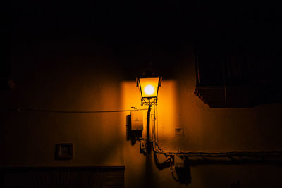 Street light against wall at night