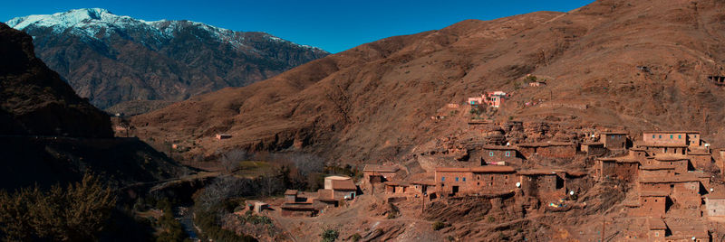 Panoramic view of village in the atlas mountains, morocco with snow capped mountain in back