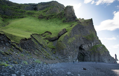 Basalt formations and cave on black sand reynisfjara beach, iceland