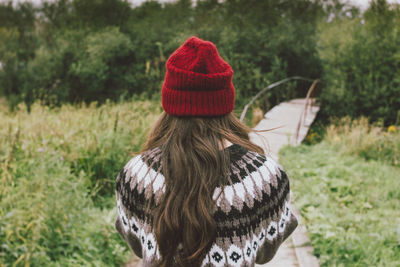 Rear view of woman wearing knit hat