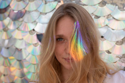 Close-up portrait of woman with light on hair