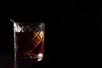 Close-up of drink in glass against black background