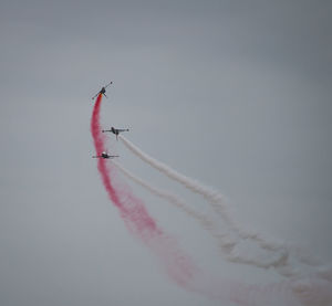 Low angle view of airplane flying against sky